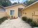 Inviting courtyard entrance with stone pavers and lush landscaping leading to the front door at 561 Portland Cir, Apopka, FL 32703