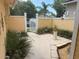 A gated courtyard is decorated with plants and flowers along the sides of the home at 561 Portland Cir, Apopka, FL 32703