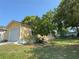 Charming home with attached garage, well-manicured lawn, and mature trees for shade at 561 Portland Cir, Apopka, FL 32703