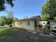 Exterior view of the house showing the side yard and covered patio area at 561 Portland Cir, Apopka, FL 32703