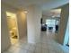 Hallway featuring tile flooring, leading to a bathroom and a living room with a fan at 561 Portland Cir, Apopka, FL 32703