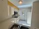 Kitchen with white cabinets, skylight, and stainless steel microwave at 561 Portland Cir, Apopka, FL 32703