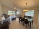 Open concept living room with tile flooring, vaulted ceiling, ceiling fan and access to a porch at 561 Portland Cir, Apopka, FL 32703