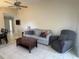 Comfortable living room featuring a sofa, chair, and a dark wooden coffee table at 561 Portland Cir, Apopka, FL 32703
