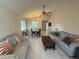 Open-concept living room with ceiling fan, tile flooring, and dining area at 561 Portland Cir, Apopka, FL 32703