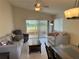 Comfortable living room area with tile flooring, lots of natural light, and a sliding door to an outdoor porch at 561 Portland Cir, Apopka, FL 32703