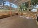 Covered patio featuring wood railing and a built-in bench, perfect for outdoor relaxation at 561 Portland Cir, Apopka, FL 32703