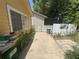 Side yard with a walkway, mature landscaping and a view of the additional structure at 561 Portland Cir, Apopka, FL 32703