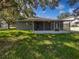 Back view of the house showing the back yard and screened in porch area at 612 Doe Cove Pl, Apopka, FL 32703