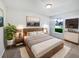 Well-lit bedroom with a modern bed frame and coordinated decor, creating a cozy atmosphere at 612 Doe Cove Pl, Apopka, FL 32703