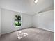 Carpeted bedroom featuring neutral walls and a bright window looking out to a green, tree-filled view at 612 Doe Cove Pl, Apopka, FL 32703