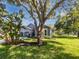 Home's exterior, showcasing landscaped front yard with mature trees at 612 Doe Cove Pl, Apopka, FL 32703