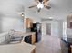 Open kitchen featuring wood cabinets, black appliances, and a breakfast bar overlooking the living area at 612 Doe Cove Pl, Apopka, FL 32703