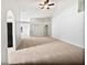 Large living room with carpet flooring, high ceilings, and arched doorways at 612 Doe Cove Pl, Apopka, FL 32703