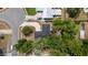 An aerial view showcases a home with a dark roof surrounded by lush trees, and a driveway that leads to the street at 6245 Sleepy Hollow Dr, Orlando, FL 32810