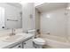 Bright bathroom featuring a toilet, tub and shower combination, a neutral color scheme and bright lighting at 6245 Sleepy Hollow Dr, Orlando, FL 32810