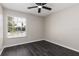 Bedroom featuring luxury vinyl plank flooring, a ceiling fan, neutral colored walls and a window at 6245 Sleepy Hollow Dr, Orlando, FL 32810