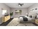 This bedroom features gray walls, dark wood-look floors, a ceiling fan and a window at 6245 Sleepy Hollow Dr, Orlando, FL 32810