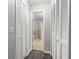 Hallway with hardwood floors leads to the bathroom with a tub/shower combo at 6245 Sleepy Hollow Dr, Orlando, FL 32810