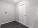 Bright laundry room featuring luxury vinyl plank flooring, neutral walls, and a white door at 6245 Sleepy Hollow Dr, Orlando, FL 32810