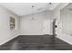 A roomy living area with new flooring, a chandelier, and large windows at 6245 Sleepy Hollow Dr, Orlando, FL 32810