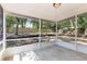 Screened porch featuring a concrete floor and a view of the large backyard at 6245 Sleepy Hollow Dr, Orlando, FL 32810