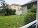 A view of the home's backyard with some lawn and perimeter landscaping at 635 Whitman Cv, Longwood, FL 32750