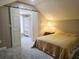 Cozy upstairs bedroom with sliding closet doors, carpet, and a small accent table at 635 Whitman Cv, Longwood, FL 32750