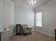 Cozy bedroom featuring neutral walls, plush carpeting, window with blinds and a decorative accent chair at 635 Whitman Cv, Longwood, FL 32750