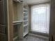 Walk-in closet featuring custom shelving, carpet and a window that provides natural light at 635 Whitman Cv, Longwood, FL 32750