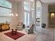 Inviting foyer with decorative chairs, a glass-topped table, and elegant lighting fixtures at 635 Whitman Cv, Longwood, FL 32750
