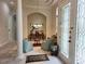 Inviting foyer with elegant decor, stylish columns, and a view into the sitting room at 635 Whitman Cv, Longwood, FL 32750