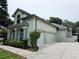 Attached two-car garage and manicured landscaping add curb appeal at 635 Whitman Cv, Longwood, FL 32750