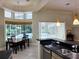 Bright kitchen with stainless steel appliances, granite countertops, tile floor, breakfast nook, and a view of the pool at 635 Whitman Cv, Longwood, FL 32750