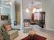 Spacious open floor plan with elegant seating, decorative lighting, and a blend of tile and carpet at 635 Whitman Cv, Longwood, FL 32750