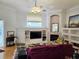 Comfortable living room with a fireplace, built-in shelving, and ceiling fan at 635 Whitman Cv, Longwood, FL 32750