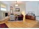 Bright living room featuring a fireplace, built-in shelving, and hardwood flooring at 635 Whitman Cv, Longwood, FL 32750