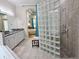 Spacious main bath with glass block shower and double sink vanity at 635 Whitman Cv, Longwood, FL 32750