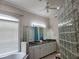 Inviting main bathroom featuring double vanity, a soaking tub, and glass block shower at 635 Whitman Cv, Longwood, FL 32750
