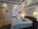 Bright main bedroom with a tray ceiling, carpeted floors, furnishings, and an open door leading to the bathroom at 635 Whitman Cv, Longwood, FL 32750