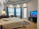 Comfortable main bedroom featuring neutral walls and a flat screen television at 635 Whitman Cv, Longwood, FL 32750