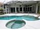 Beautiful pool and spa area with screened enclosure offers outdoor enjoyment and relaxation at 635 Whitman Cv, Longwood, FL 32750