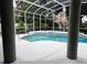 Inviting screened-in pool area with a nearby house at 635 Whitman Cv, Longwood, FL 32750