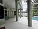 Back patio area with columns overlooking an enclosed in-ground pool at 635 Whitman Cv, Longwood, FL 32750
