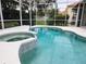 Inviting in-ground pool and hot tub with a screened-in lanai, perfect for outdoor entertainment at 635 Whitman Cv, Longwood, FL 32750