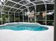 Charming screened-in pool area with a nearby house at 635 Whitman Cv, Longwood, FL 32750