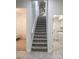 Carpeted staircase with white banister leading to the upper level, flanked by doorways to other rooms at 635 Whitman Cv, Longwood, FL 32750