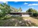 Rear exterior view showing screen enclosed lanai on a sunny day at 7024 Harwick Dr, Orlando, FL 32818
