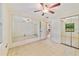 Bedroom featuring a mirrored wall, ceiling fan, and tiled floors at 7024 Harwick Dr, Orlando, FL 32818