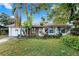 Charming single story home with brick accents, mature landscaping, and white painted garage at 7024 Harwick Dr, Orlando, FL 32818